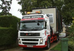 The next classroom section arrives on a truck